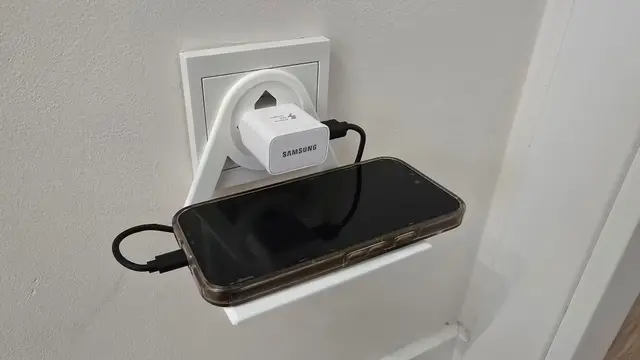 Mobile phone holder plugged into a European socket — modelo 3D